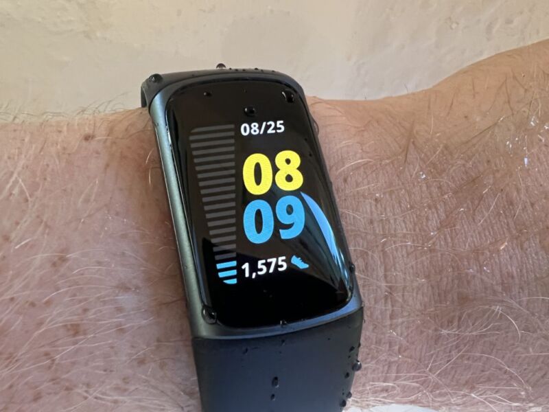 Fitbit Charge 5 fitness tracker wearable on a person's arm,